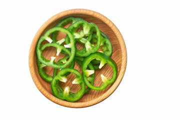 Wall Mural - Sliced green bell pepper in a wooden bowl isolated on white background.  Top view.