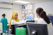 © Trevor Adeline/Caia Image - Female scientists using laptop in laboratory