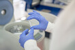 © Trevor Adeline/Caia Image - Close up scientist in rubber gloves placing specimen in centrifuge