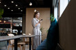 © WavebreakMediaMicro - Asian woman using smartphone in creative office cafeteria