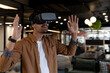 © WavebreakMediaMicro - Mixed race businessman wearing virtual reality headset in creative office