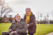 © Monkey Business - Senior Woman Pushing Senior Man In Wheelchair Outdoors In Fall Or Winter Park