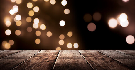 Wooden holiday empty table, night view, blurred bokeh lights background.