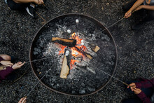 Children Toasting Marshmallows On Campfire Overhead View