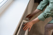 © Angelov - Closeup of a radiator thermostat with woman hand