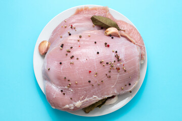 Wall Mural - raw turkey with black pepper and garlic on dish