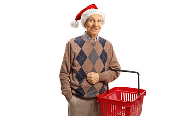 Canvas Print - Elderly man with a shopping basket and a christmas hat giving a thumb up