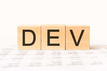 Word dev. Wooden small cubes with letters isolated on white background with copy space available