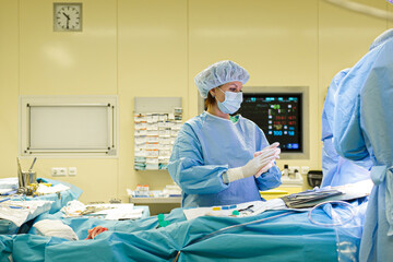 Wall Mural - The doctor's assistant helps the surgeon during the operation