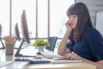 Beautiful, stressful employee at the office desk