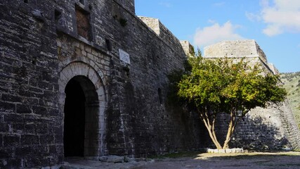 Wall Mural - Arched gate of medieval fortress with stone walls in Mediterranean coast of Albania