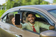 © PRASANNAPIX - Young indian business man or employee sitting in car and showing mobile screen