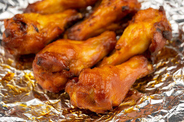 Shot of drumette chicken wing stick grilled on aluminium foil