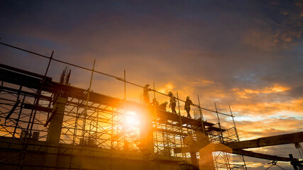 Wall Mural - Silhouette Engineer and construction team working at site over blurred  industry background with Light fair Film Grain effect.Create from multiple reference images together