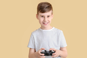 Wall Mural - Cute boy with game pad on color background