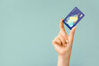 Leinwandbild Motiv Female hand with credit card on color background