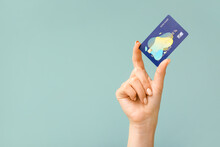 Female Hand With Credit Card On Color Background