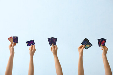 Poster - Female hands with credit cards on light background