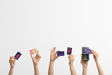 Poster - Female hands with credit cards and payment terminal on white background