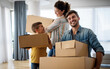 © NDABCREATIVITY - Happy young family unpacking cardboard boxes at new home