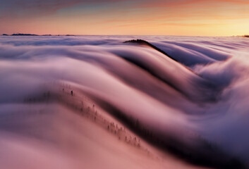 Wall Mural - beautiful landscape, misty fog on mountain slopes, abstract view over clouds.