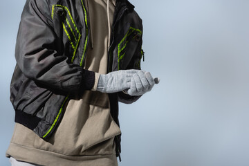  cropped view of man in anorak and gloves isolated on grey