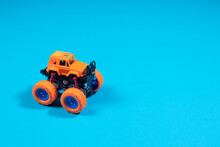Children's Toy Truck On Blue Background With Place Copy Space For Text - Boy's Car, Toy Store
