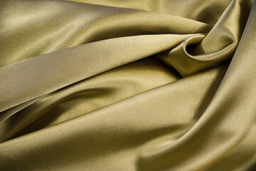 Wall Mural - Golden yellow abstract background. Beautiful folds on shiny fabric. Silk satin texture background. Elegant gold background.