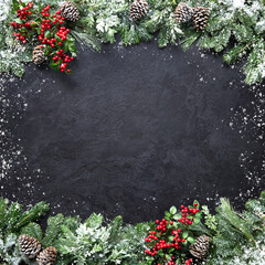 Wall Mural - christmas and new year background with fir branches and snowfall on dark stony board