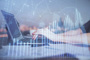 Double exposure of businesswoman hands typing on computer and forex chart hologram drawing. Financial analysis concept.