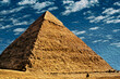 Stunning view of Giza pyramids complex, an old necropolis for pharaohs. Located southwest of Cairo, this ancient Egyptian wonder is one of the world biggest tourist attractions. Oil paint filter.
