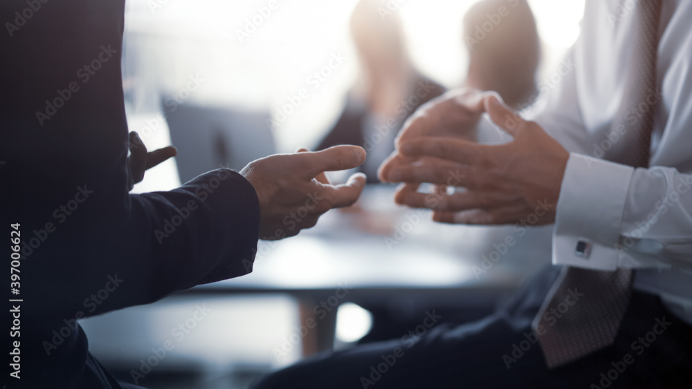 Close up. Meeting of project leaders. Hands of a business people having a project discussion or business agreement together. Team work process. Blurred background. 16x9 size - obrazy, fototapety, plakaty 