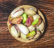 Salty pistachio snack on wooden background, directly above