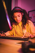 © LIGHTFIELD STUDIOS - Tensed african american gamer using computer keyboard while playing video game
