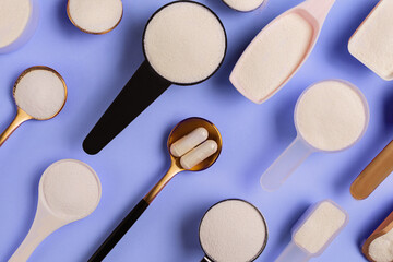 collagen powder and pills spoons on blue background. extra protein intake. natural beauty and health