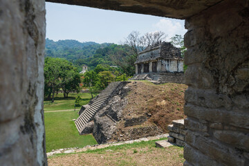 Wall Mural - View through gate to small pyramid Mayan ruin temple at the archaeological site of Palenque, Chiapas, Mexico