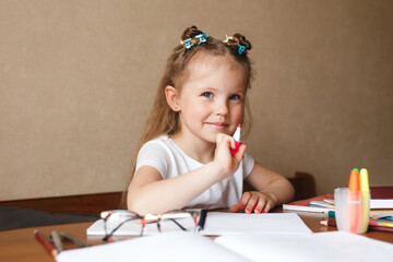 Child doing homework writing and reading at home