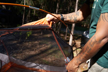 Black Man Setting Up Camping Tent