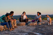© Mhandy/Creative Flame - Friends enjoying weekend getaway on mountain top at sunset