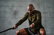 © B. Alyssa Trofort/Creative Flame - Black man training with battle ropes in crossfit