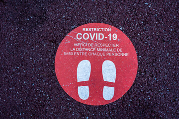 Footprint floor sticker, foot steps in circle, keep distance waiting in line, stand here sign, coronavirus or Covid-19 prevention, social distance. High quality photo