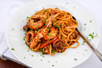 Wall Mural - Pasta with grilled seafood. Traditional Greek dish.