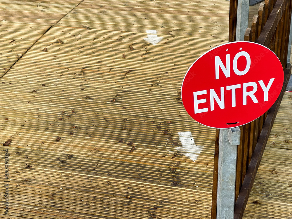 No Entry sign at the exit to a wooden decking area in an outdoor market ...