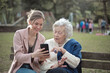 © olly - granddaughter explains to grandmother how to use a smartphone