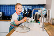 a boy helps his parents wash dishes.