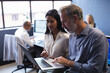 © Wavebreak Media - Diverse man and woman working together in creative office, using laptop