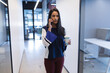 © Wavebreak Media - Mixed race woman using smartphone in creative office