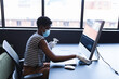© Wavebreak Media - African american woman wearing face mask wiping computer in office