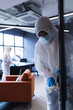 © Wavebreak Media - Health workers in protective clothing disinfecting creative office