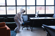 © Wavebreak Media - Health worker in protective clothing spraying disinfectant in office
